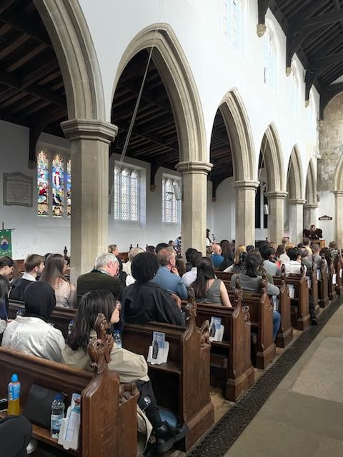 people sat in pews in church