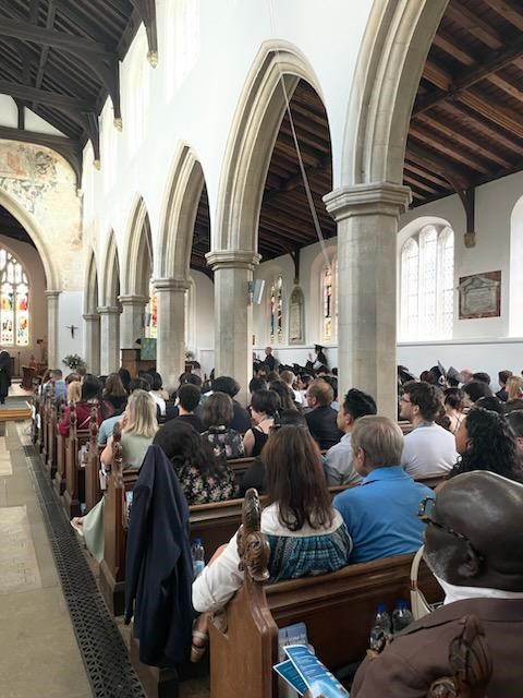 people sat in pews in church